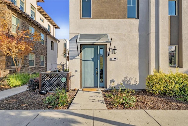 doorway to property featuring central air condition unit