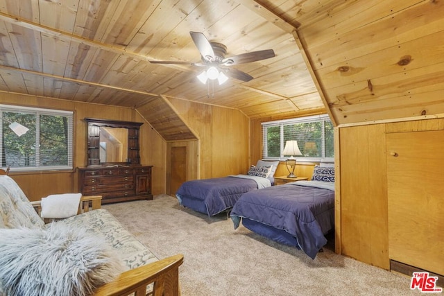 carpeted bedroom featuring multiple windows, vaulted ceiling, wooden ceiling, and wood walls