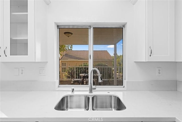 kitchen featuring white cabinetry and sink