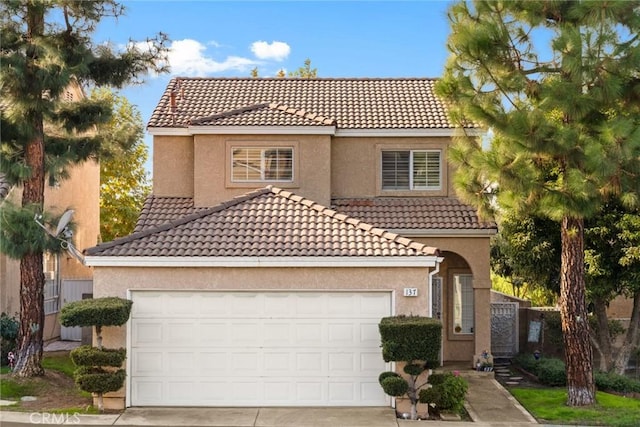 mediterranean / spanish-style house with a garage