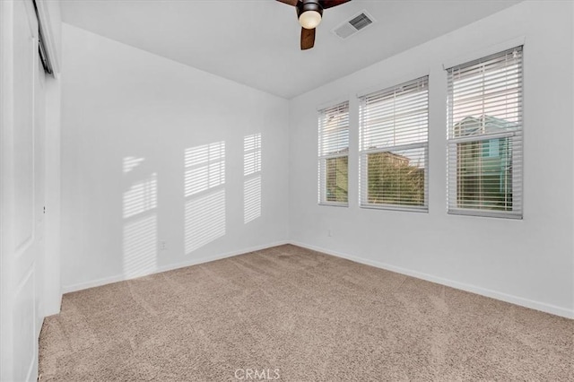 spare room featuring carpet flooring and ceiling fan