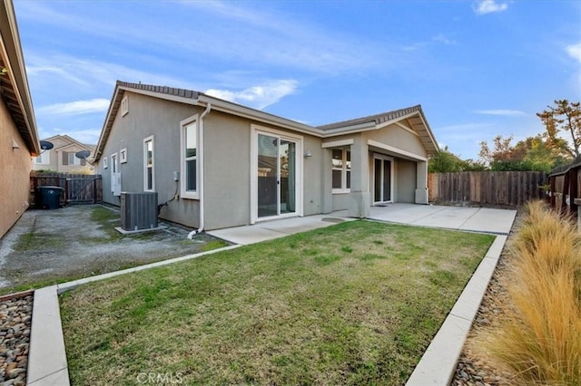 back of property featuring a lawn, a patio area, and central air condition unit