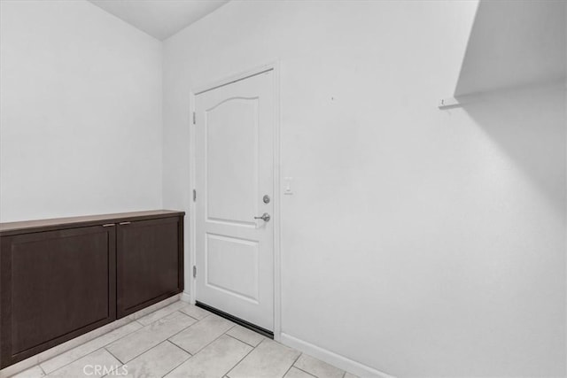 doorway to outside with light tile patterned flooring