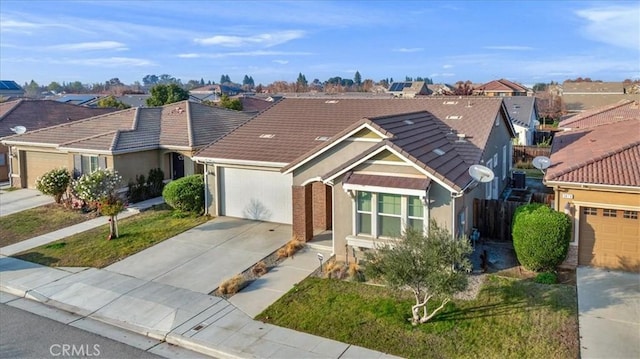 ranch-style house with a garage and a front lawn