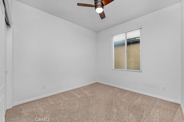 carpeted spare room with ceiling fan