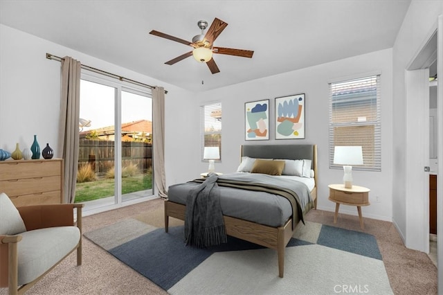 carpeted bedroom with ceiling fan and multiple windows