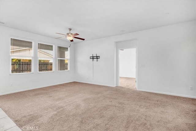 spare room featuring ceiling fan and light colored carpet