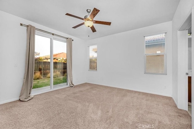 spare room featuring ceiling fan and light colored carpet