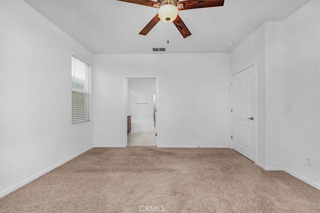 carpeted spare room with ceiling fan