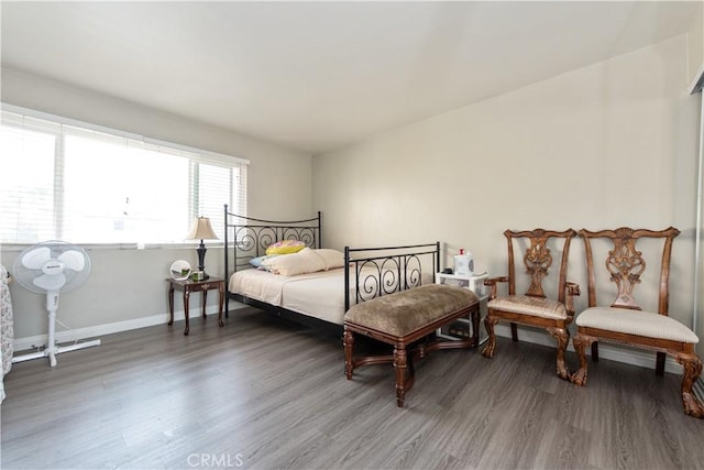 bedroom with wood finished floors and baseboards