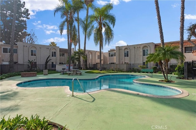 view of pool featuring fence