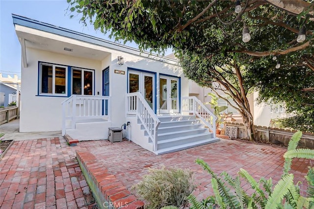 view of front of property featuring french doors and a patio