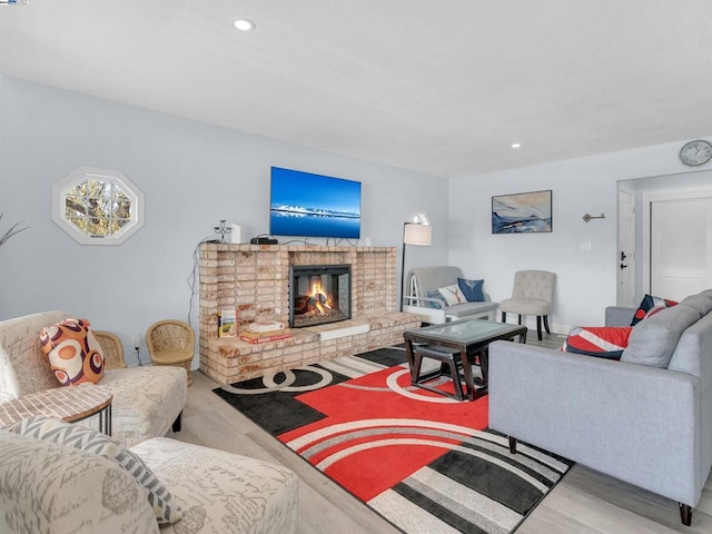 living room with a fireplace and light hardwood / wood-style flooring