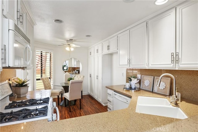 kitchen featuring white cabinets, dark hardwood / wood-style floors, white appliances, and sink