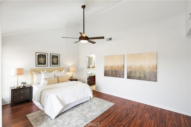 bedroom featuring ceiling fan, dark hardwood / wood-style floors, ensuite bathroom, and high vaulted ceiling