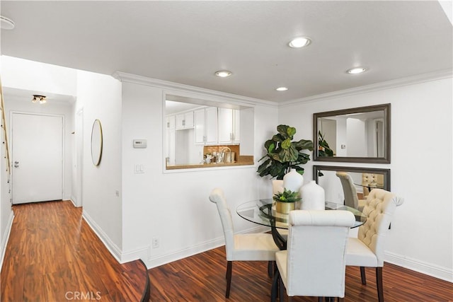 dining space featuring dark wood-type flooring and ornamental molding