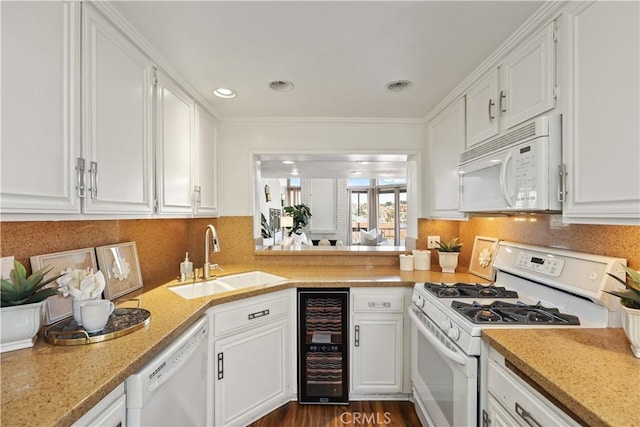 kitchen with wine cooler, sink, white cabinets, and white appliances