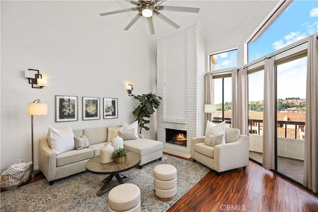 sunroom / solarium with ceiling fan and a brick fireplace