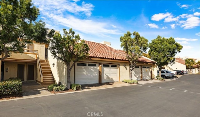 mediterranean / spanish house with a garage