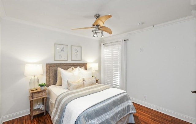 bedroom with ceiling fan, dark hardwood / wood-style flooring, and crown molding