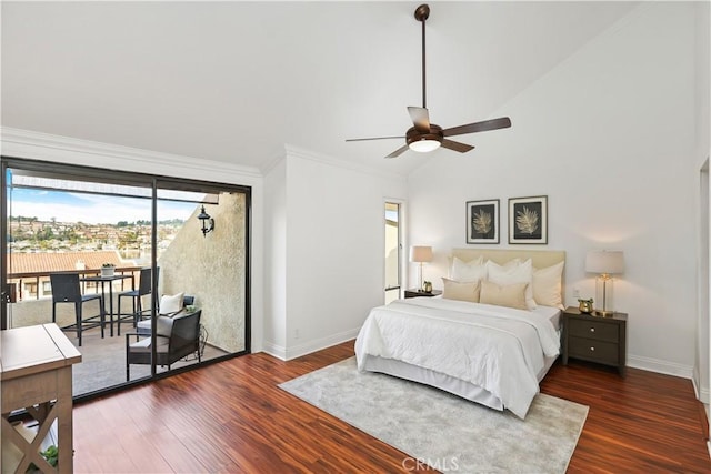 bedroom featuring dark hardwood / wood-style floors, ceiling fan, access to exterior, and vaulted ceiling