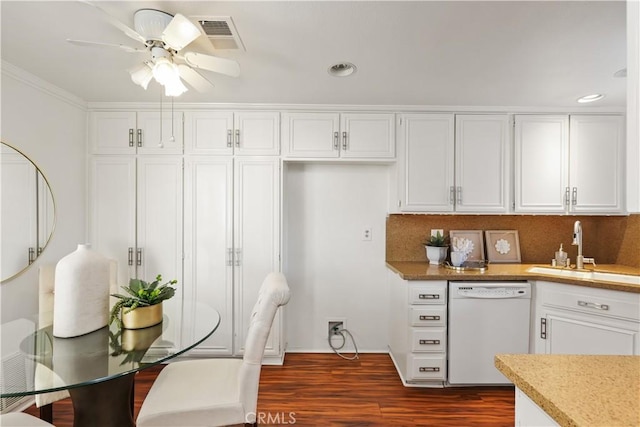 kitchen with dishwasher, white cabinetry, and sink