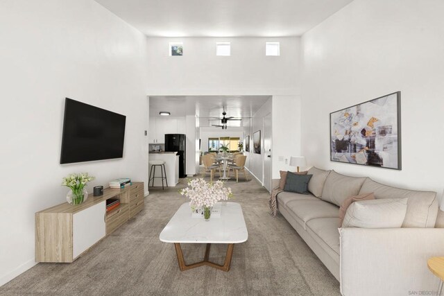 living room featuring ceiling fan and light carpet