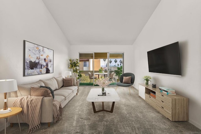 carpeted living room featuring high vaulted ceiling