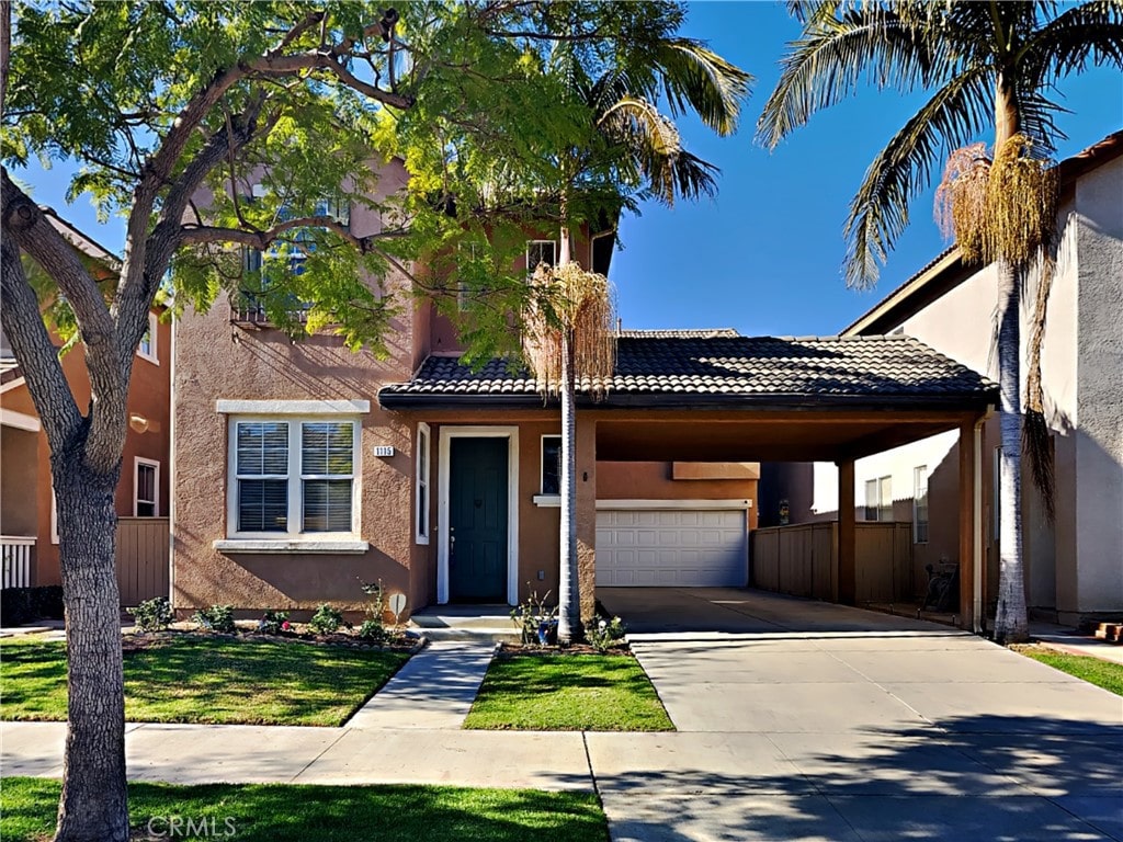 view of front of home featuring a garage and a carport