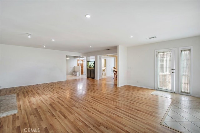 unfurnished living room with light wood-type flooring