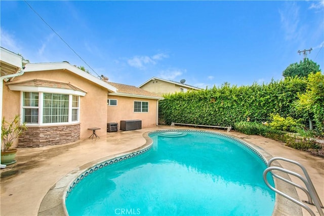 view of swimming pool featuring a patio and central AC unit