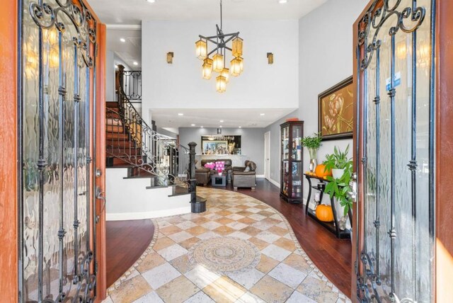 entryway with a high ceiling and an inviting chandelier