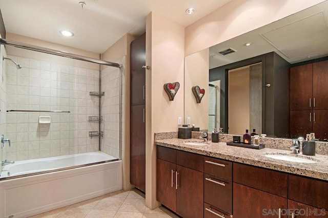 bathroom featuring vanity, tile patterned floors, and enclosed tub / shower combo