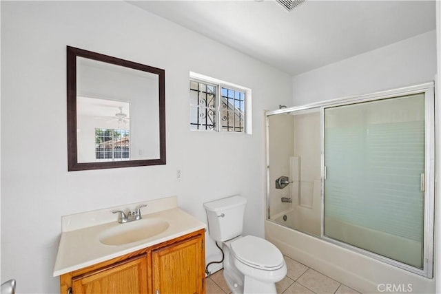 full bathroom with tile patterned floors, vanity, ceiling fan, enclosed tub / shower combo, and toilet