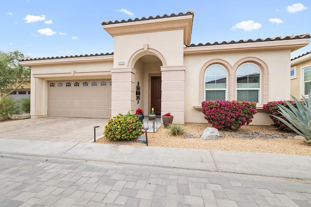 mediterranean / spanish house with a garage