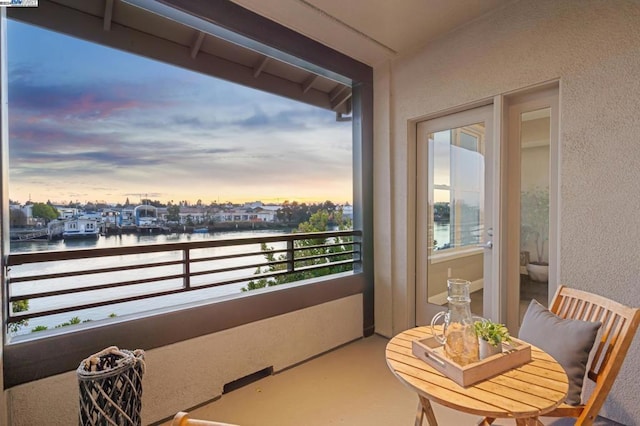 balcony at dusk with a water view