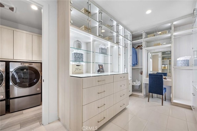 interior space with cabinets, separate washer and dryer, and light tile patterned flooring