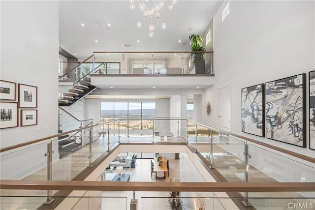 interior space with tile patterned flooring, a high ceiling, and a notable chandelier