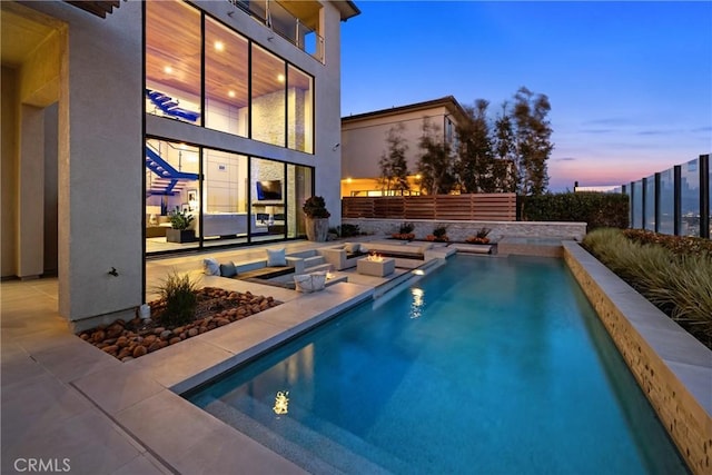 view of pool at dusk