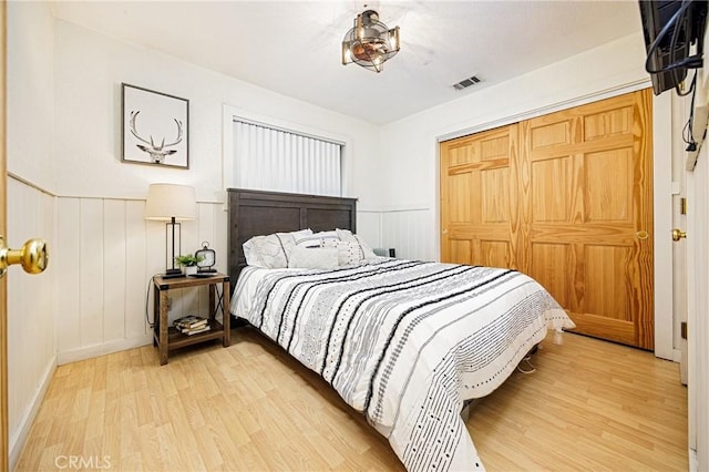 bedroom with hardwood / wood-style floors and a closet