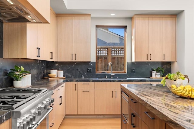 kitchen featuring light brown cabinets and stainless steel range