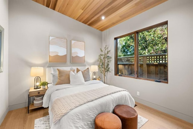 bedroom featuring wood ceiling and light hardwood / wood-style floors