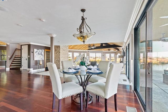 dining area featuring dark hardwood / wood-style floors, plenty of natural light, and crown molding