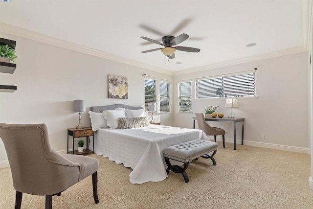 carpeted bedroom featuring ceiling fan and crown molding