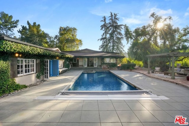 view of pool with a pergola and a patio