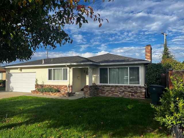 view of front of property with a garage and a front lawn