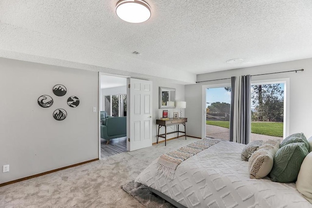 carpeted bedroom featuring access to exterior and a textured ceiling