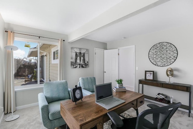 carpeted home office with beamed ceiling