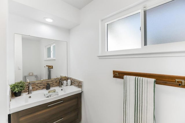 bathroom featuring toilet and vanity