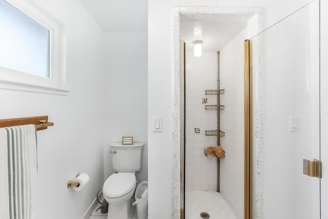 bathroom featuring toilet and a shower with door